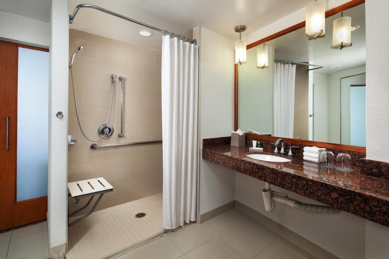 Barrierefreies Zimmer mit rollstuhlgerechter Dusche und Stadtblick.