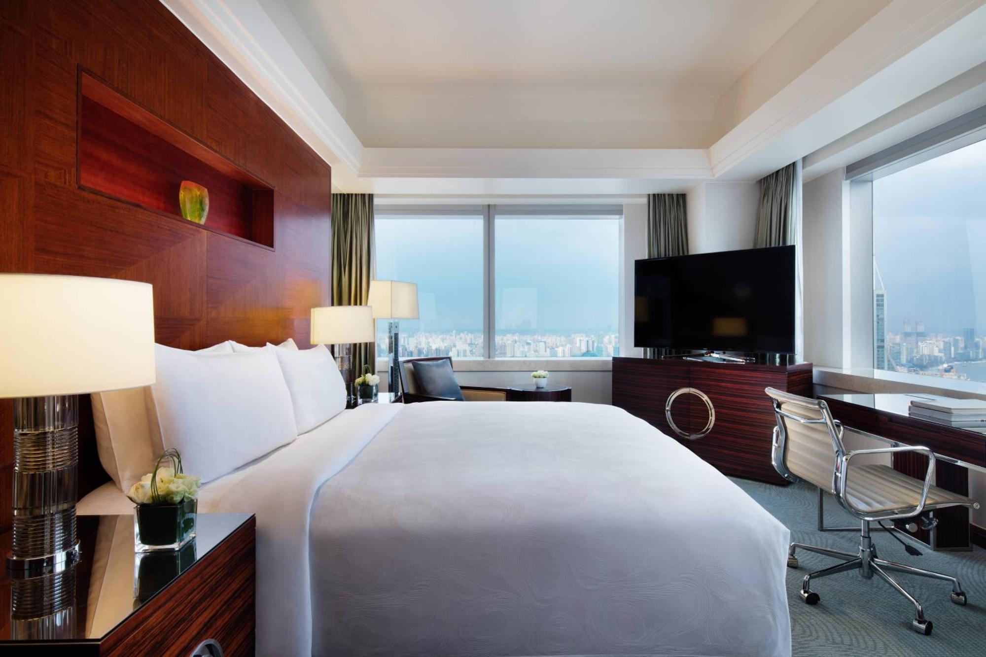 Eckzimmer mit Kingsize-Bett und Blick auf die Skyline